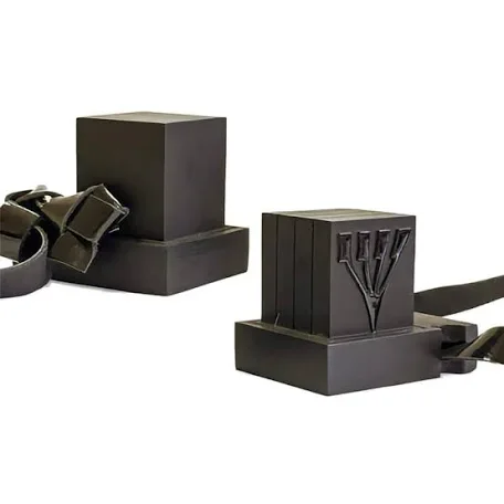 A pair of black tefillin with leather straps